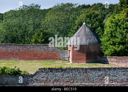 Old historic walled garden with thatched octagonal building, Basing House, Basingstoke, Surrey, England. Stock Photo