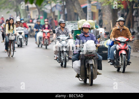 People riding scooters/mopeds in Vietnam in Hanoi Stock Photo