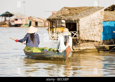 Local women in a boat on Tong Le Sap Lake in Cambodia Stock Photo