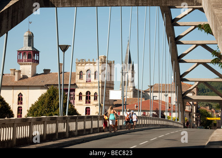 People crossing the bridge over the River Lot at Castelmoron, Aquitaine France Stock Photo
