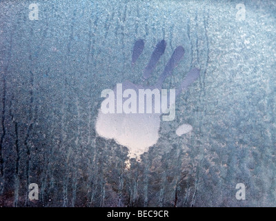 Handprint on a frosty car window. Stock Photo