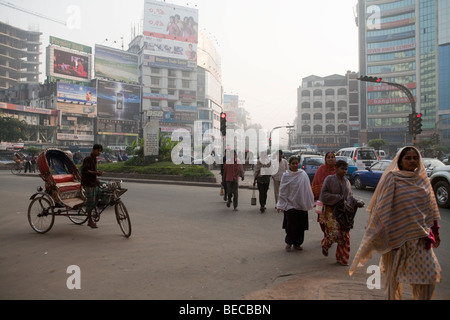 Garment workers walking to work in Dhaka Bangladesh Stock Photo