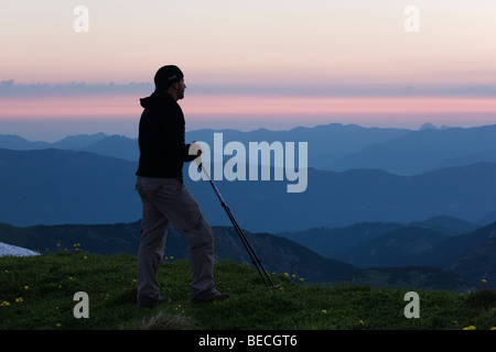 Hiker looking at mountains after sunset, Rofan Range, North Tyrol, Austria, Europe Stock Photo