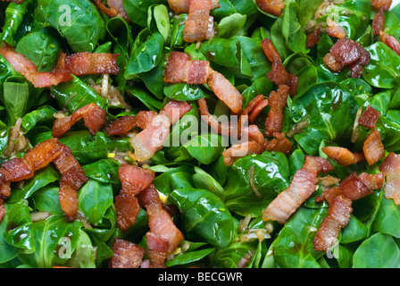 Field salad (Valerianella locusta) with roasted bacon strips Stock Photo