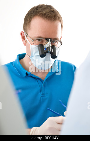 Dentist wearing magnifying glasses Stock Photo