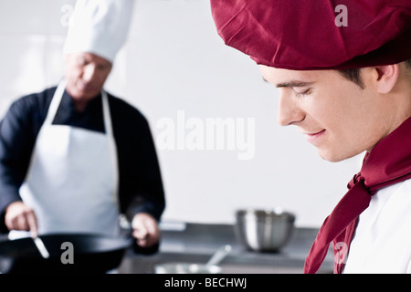 Two chefs cooking food in the kitchen Stock Photo