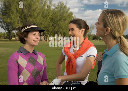 Three golfers standing in a golf course and smiling, Biltmore Golf Course, Coral Gables, Florida, USA Stock Photo