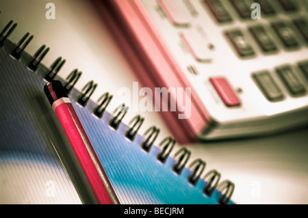 Close-up of a pencil and a spiral notebook and a calculator Stock Photo