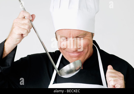Chef smelling the cooked food Stock Photo