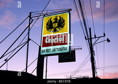 Evening mood with power lines and neon lights, sign for the Imperial Bar, Sabanilla, San Jose, Costa Rica, Central America Stock Photo