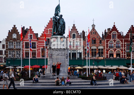 Freedom fighter monument, in the back houses with stepped gables and restaurants, Market Square, Bruges, Belgium, Europe Stock Photo