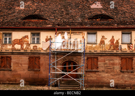 Scaffolding for the restauration of an old mural on a tavern, Nuremberg-Buch, Middle Franconia, Bavaria, Germany, Europe Stock Photo