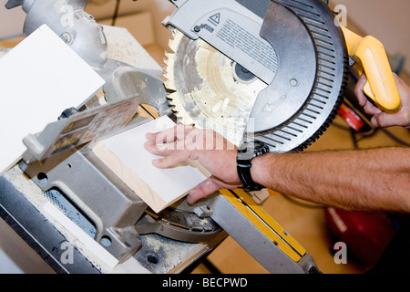 Close-up of a person's hand using a circular saw Stock Photo