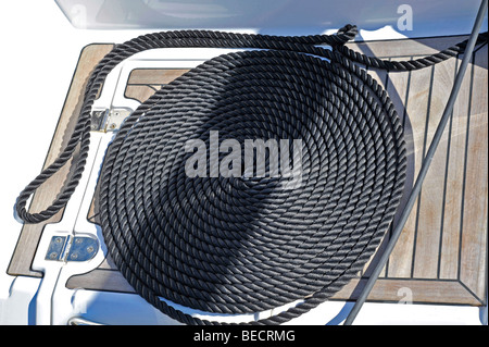 Coiled rope on teak deck. Decorative coiling is called 'cheesing' or ...