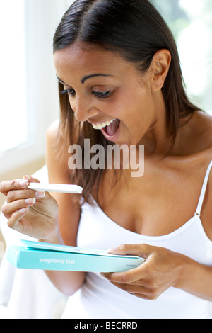 Girl happy with pregnancy test Stock Photo