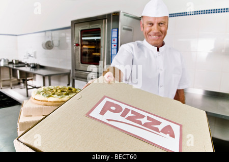 Chef holding a pizza box Stock Photo