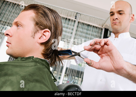 Man receiving a haircut in a salon Stock Photo