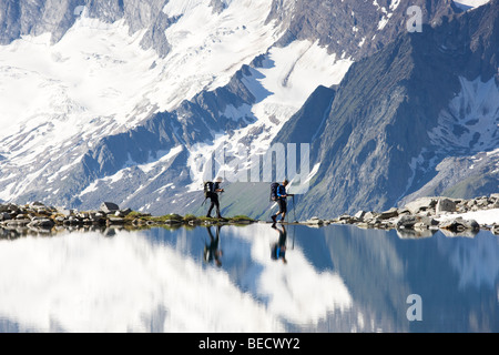 Hikers on the shore of the Friesenbergsee lake, Zillertal Alps, Northern Tyrol, Austria, Europe Stock Photo