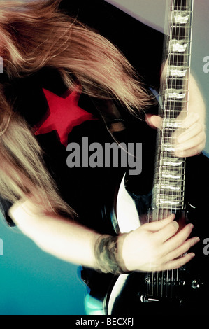 Mid section view of a person playing a guitar Stock Photo