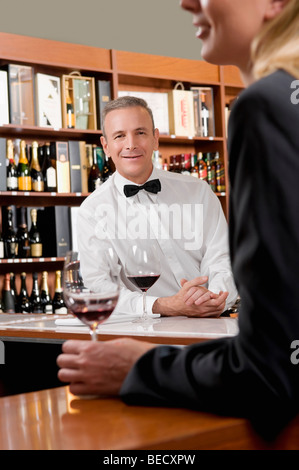 Businesswoman holding a glass of wine in a bar Stock Photo