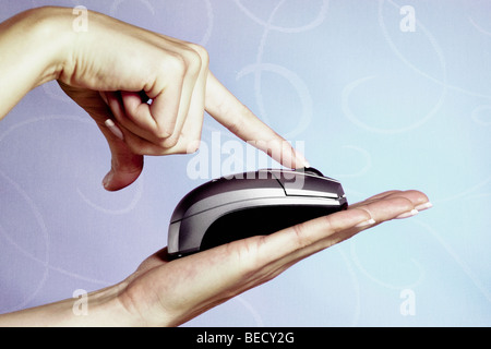 Close-up of a woman's hand using a computer mouse Stock Photo