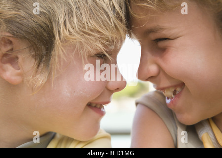 Two friends looking at each other and smiling Stock Photo
