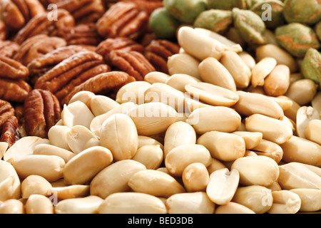 Mixed nuts, full format, peanuts, salted pistachios, pecan nuts Stock Photo