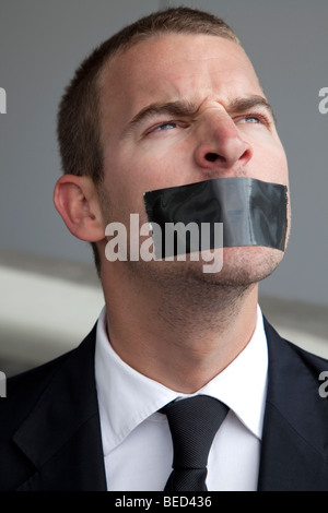 Business man silenced with tape on mouth Stock Photo