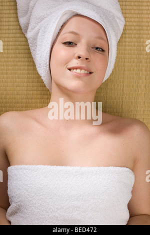 Young woman relaxing in a spa, towel wrapped around her head Stock Photo