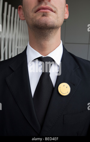 Close up on mans suit and a smiley on lapel Stock Photo