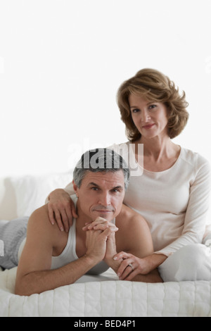 Couple relaxing on the bed Stock Photo