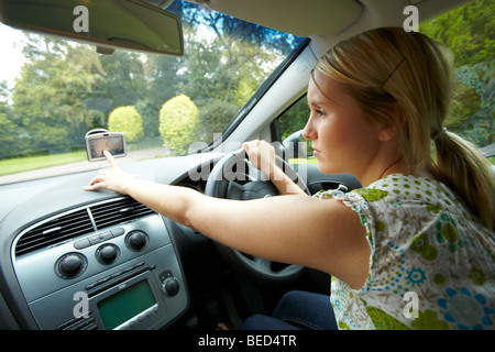 Girl driving car using phone Stock Photo