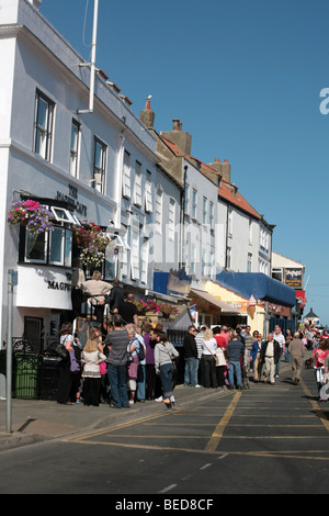 Visitors queuing outside The Magpie Cafe Whitby North Yorkshire England Stock Photo