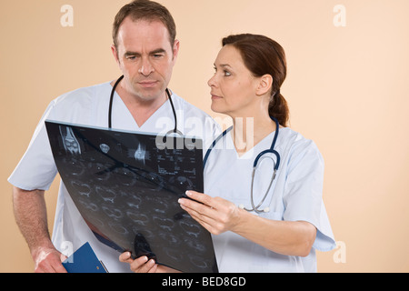 Two doctors talking about the results of an X-ray Stock Photo