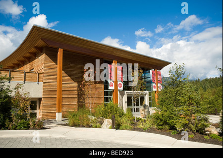 Totem poles in front of the Lil'wat Native Cultural Centre. Whistler BC, Canada Stock Photo