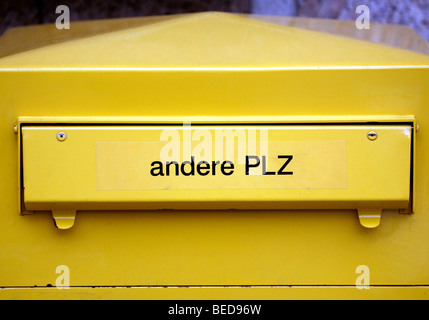 Yellow postbox of the Deutsche Post AG Stock Photo