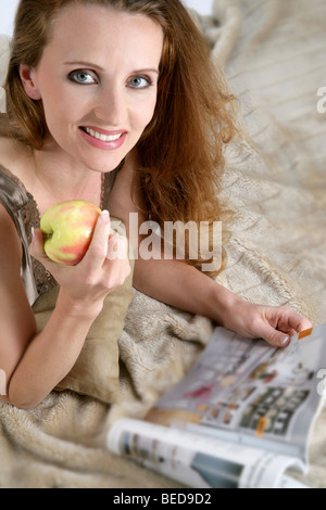 Woman holding an apple Stock Photo