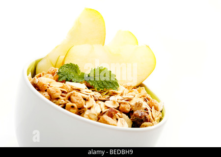 Fruit muesli and apples in a bowl Stock Photo