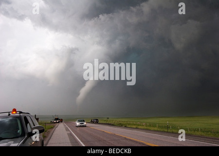 Storm chasers with Project Vortex 2 watch a tornado cross the highway in Goshen County, Wyoming, USA, June 5, 2009. Stock Photo
