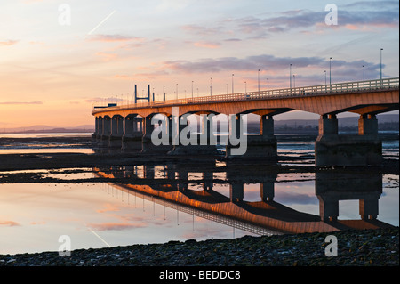 A sunset view of the Second Severn Crossing motorway bridge, Bristol, UK, seen from Aust on the English side of the Severn estuary at low tide Stock Photo