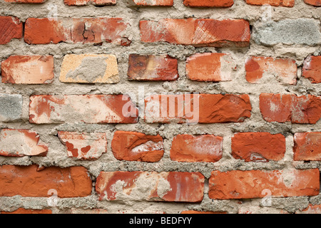 Old brick wall of red color with cracks and stains Stock Photo