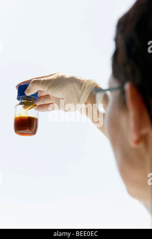 Examining a fluid, lab scene Stock Photo
