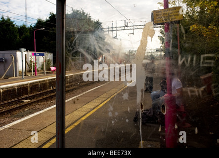 A vandalised plexiglass shelter on the platform of a train station in Essex..  Photo by Gordon Scammell Stock Photo