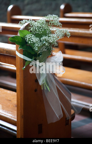 Wedding Posy on Church pew Stock Photo