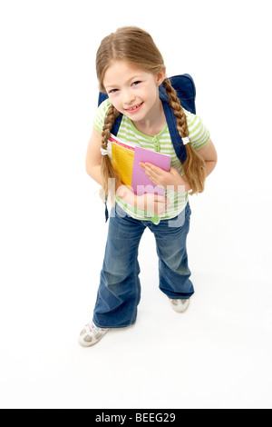 Studio Portrait of Smiling Girl Holding School Book Stock Photo