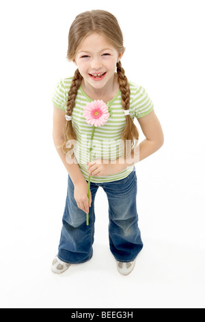 Studio Portrait of Smiling Girl Holding Flower Stock Photo