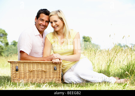 Young couple having picnic in countryside Stock Photo
