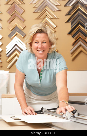 Female picture framer at work Stock Photo