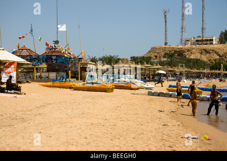 Tourists enjoying the sun at Naama Bay beach, Sharm el Sheikh, Red Sea, Egypt Stock Photo