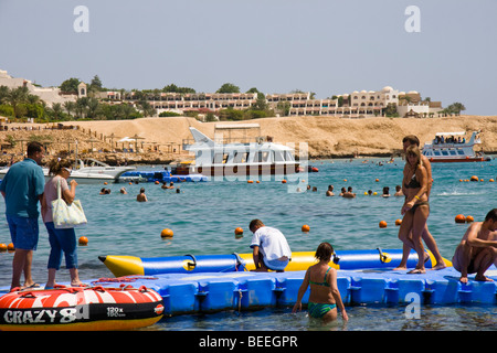 Tourists enjoying the sun at Naama Bay beach, Sharm el Sheikh, Red Sea, Egypt Stock Photo